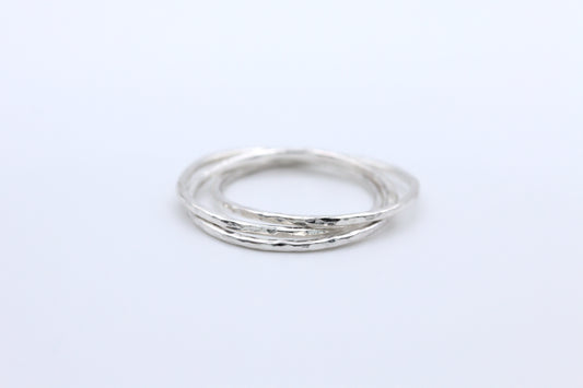 an interlocking ring with 3 hammered bands, a triple rolling ring