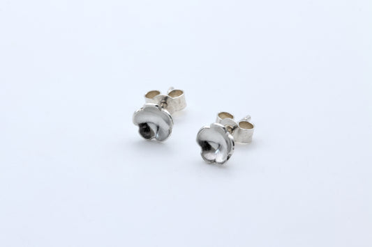 A pair of dainty silver flower stud earrings