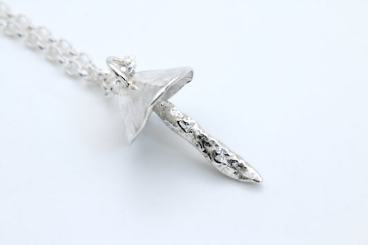 A handcrafted silver fungi pendant