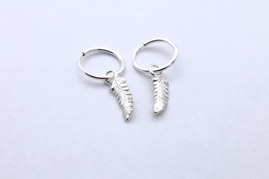 a tiny pair of fern leaf hoop earrings in silver