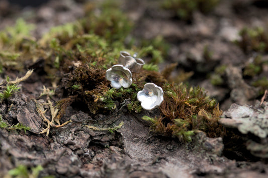 A pair of dainty silver flower stud earrings
